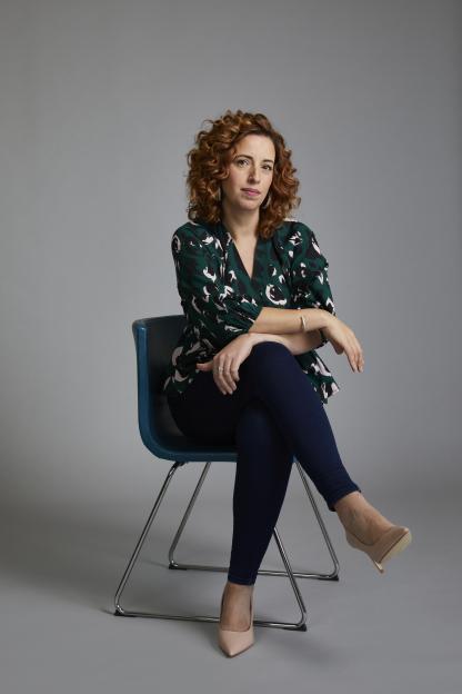 Portrait of Sarah Ibrahim sitting in a chair.