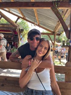 Couple embracing at Glastonbury Festival.