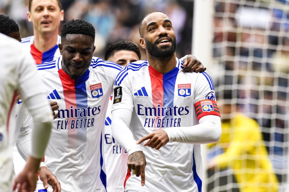 Lyon soccer players celebrating a goal.