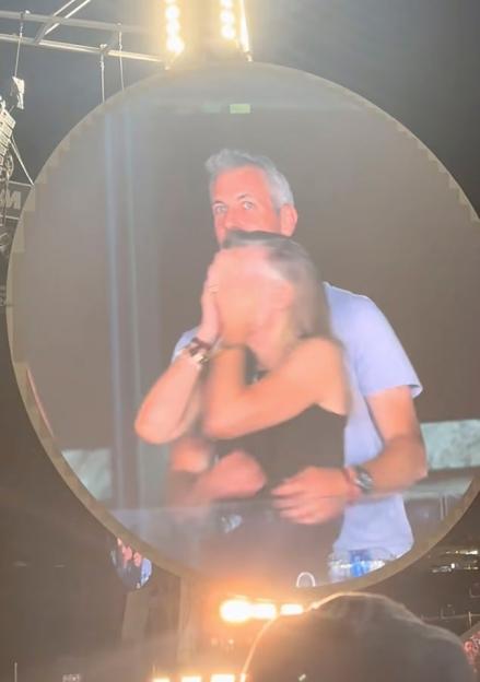 Couple embracing on a large screen.