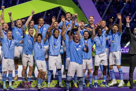 JEDDAH, SAUDI ARABIA - DECEMBER 22: Players of Manchester City celebrate their victory on the podium after the FIFA Club World Cup Final match between Manchester City and Fluminense at King Abdullah Sports City in Jeddah, Saudi Arabia on December 22, 2023. Manchester City defeated Fluminense 4-0 to win the 2023 FIFA Club World Cup. (Photo by Mohammed Saad/Anadolu via Getty Images)