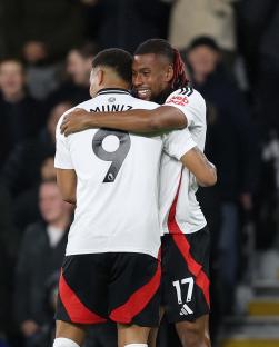 Alex Iwobi and Rodrigo Muniz celebrating a Fulham goal.