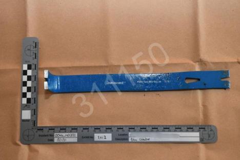 Photo of a blue crowbar at a crime scene.