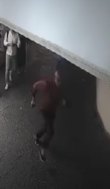 Surveillance image of a person running.