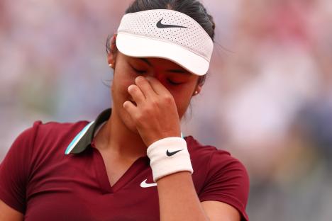 Emma Raducanu appearing upset during a tennis match.