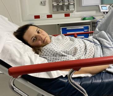 Woman lying in a hospital bed.