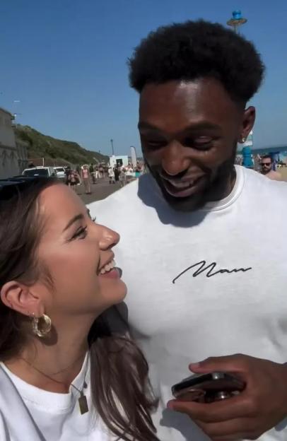A man and woman smiling at each other.