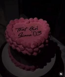 Heart-shaped cake decorated with pink frosting and the words