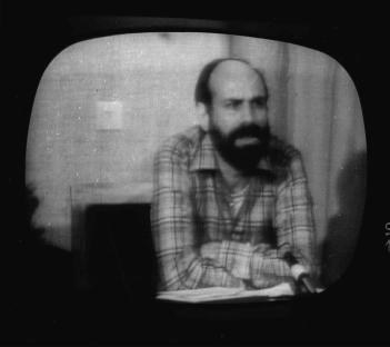 Black and white television screen showing Barry Rosen, an American hostage held in Iran, reading a message.