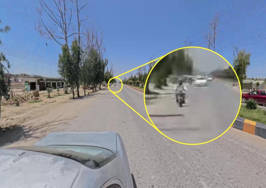 A blurry photo of a Taliban guard on a motorcycle in Kandahar, Afghanistan.