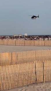 Police helicopter breaking up a beach brawl.