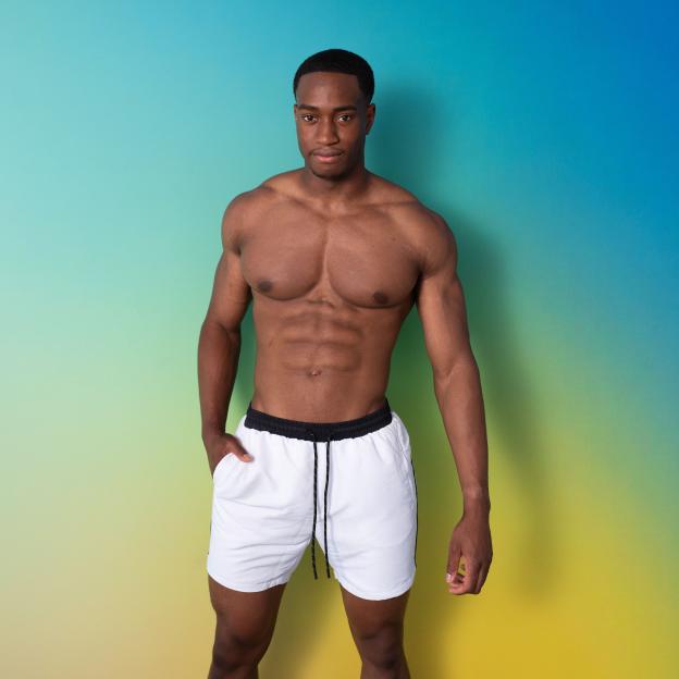 Martin, a 23-year-old graduate from Love Island, posing in white shorts.
