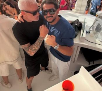 Wayne Lineker and another man posing together.
