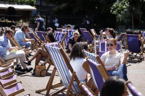 People relaxing in deck chairs during a heatwave.