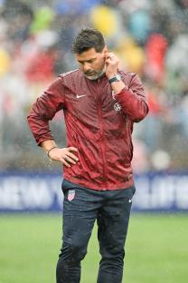 Mauricio Pochettino, head coach of the United States men's national soccer team, on the sidelines during a rain-soaked match.