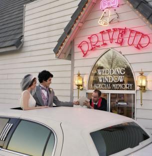 Newlyweds receive their marriage certificate at a drive-thru wedding chapel.