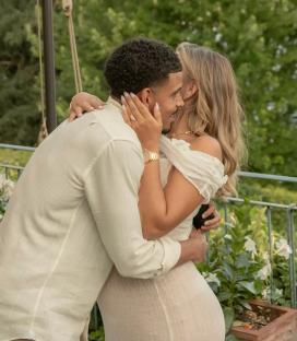 Couple embracing outdoors.