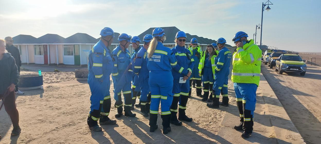 Coastguard team on a beach.