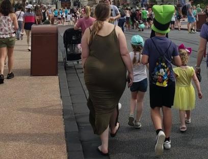 Family walking toward Cinderella Castle at Disney World.