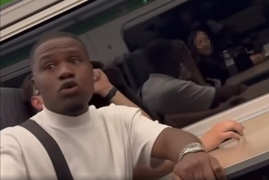 Screenshot of a man on a train making threats.