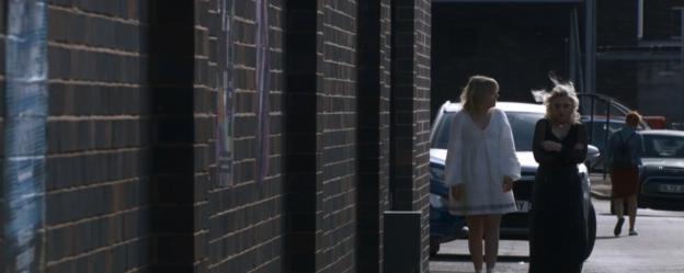 Screenshot of two girls walking down a street.