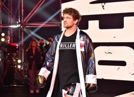 Ben Askren entering a boxing ring.