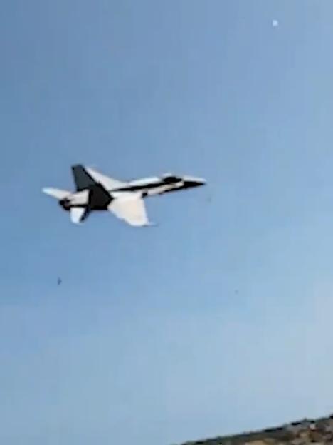 Jet plane flying in a clear blue sky.