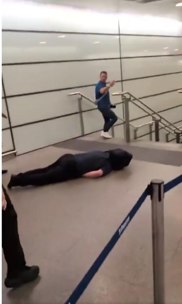 Person lying on the floor of St. Pancras railway station.