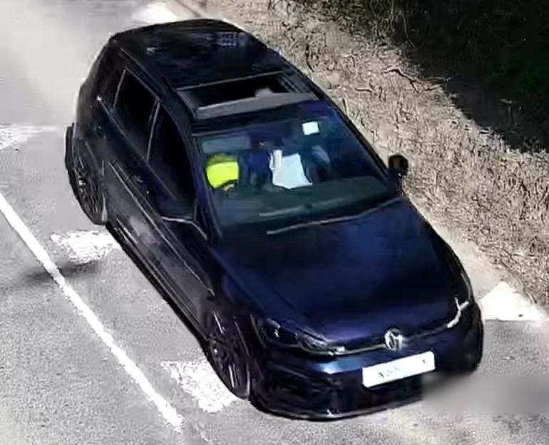 Handout video grab of a dark-blue Volkswagen Golf.