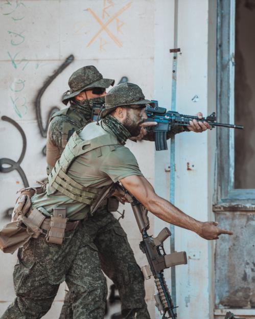 Two soldiers aiming rifles.