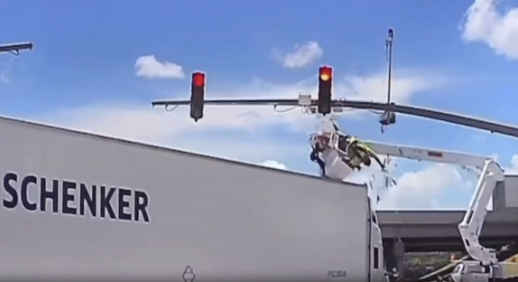 Traffic light falling onto a Schenker truck.
