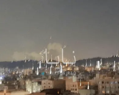 Nighttime view of a city with fireworks.