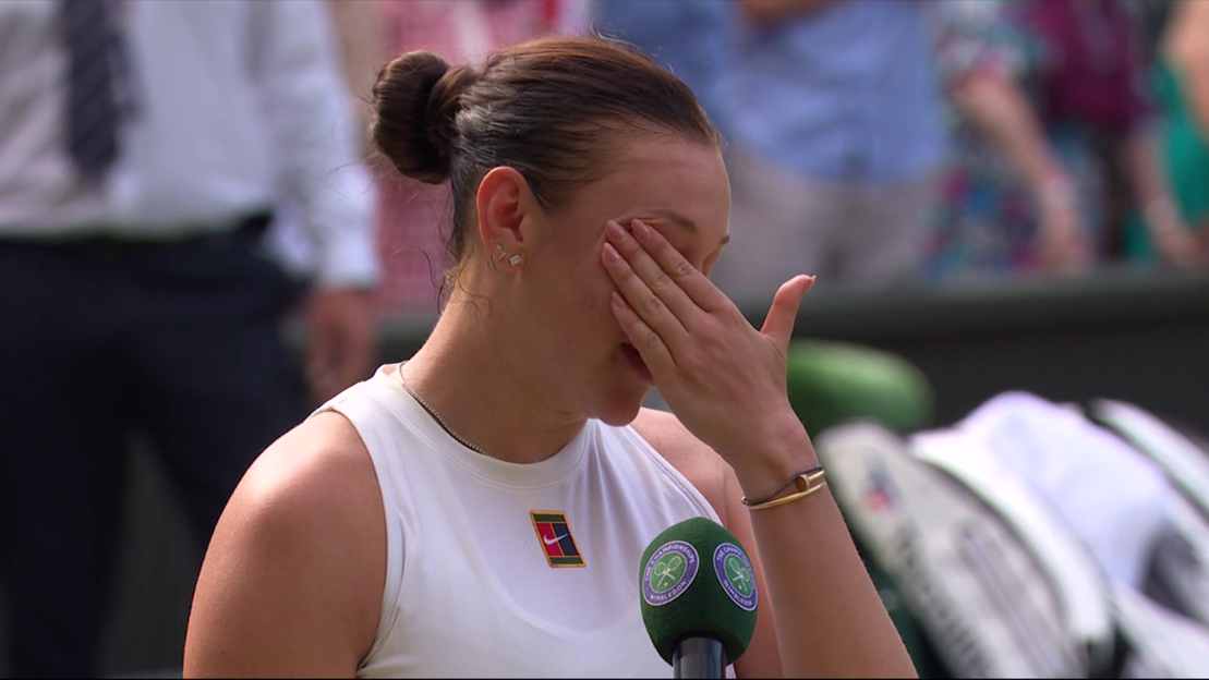 A tennis player crying during a post-match interview.