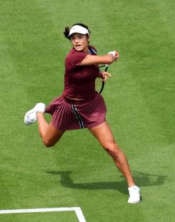 Emma Raducanu playing tennis.