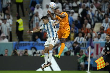 Marcos Acuna of Argentina and Denzel Dumfries of the Netherlands vying for the ball during a World Cup quarterfinal match.
