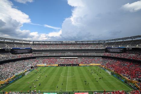 MetLife Stadium during a soccer match; the players are leaving the field due to bad weather.