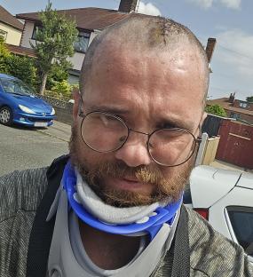 Man in neck brace with head wound.