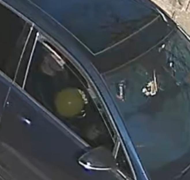 Handout video grab of a driver inhaling nitrous oxide from a balloon.