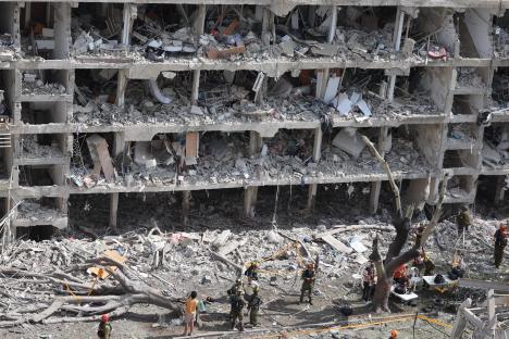 Emergency personnel at the site of a destroyed building in Tel Aviv.