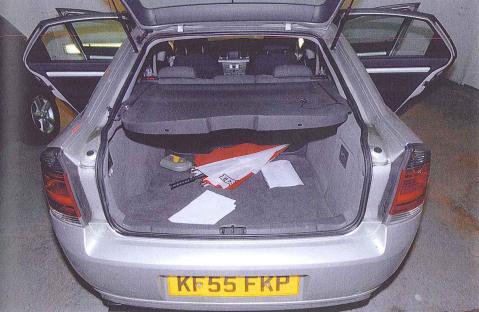 The open trunk of a silver Vauxhall Vectra car.