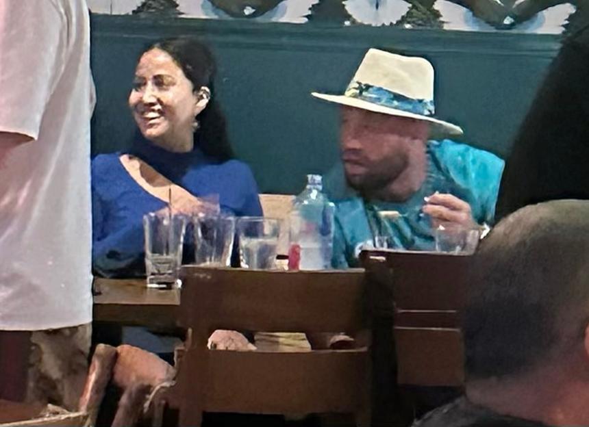 Conor McGregor and a woman at a restaurant.