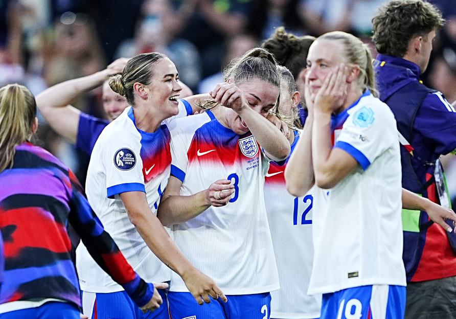 England's women's football team celebrating a victory.