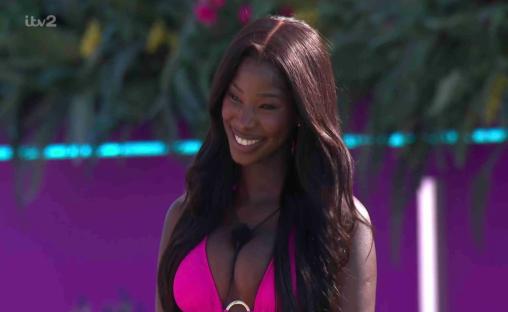 Smiling woman in pink bikini top.