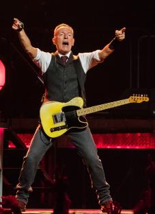 Bruce Springsteen performing with a guitar.