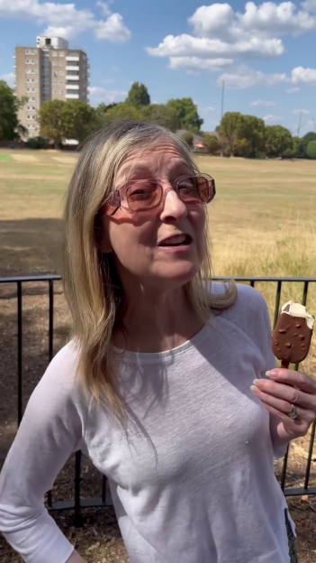 Fiona Phillips holding an ice cream bar outdoors.