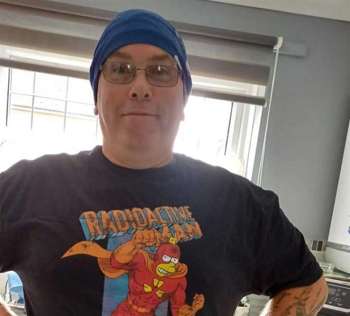 A man wearing a Radioactive Man t-shirt.