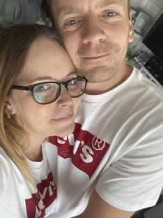 Close-up selfie of a couple embracing.