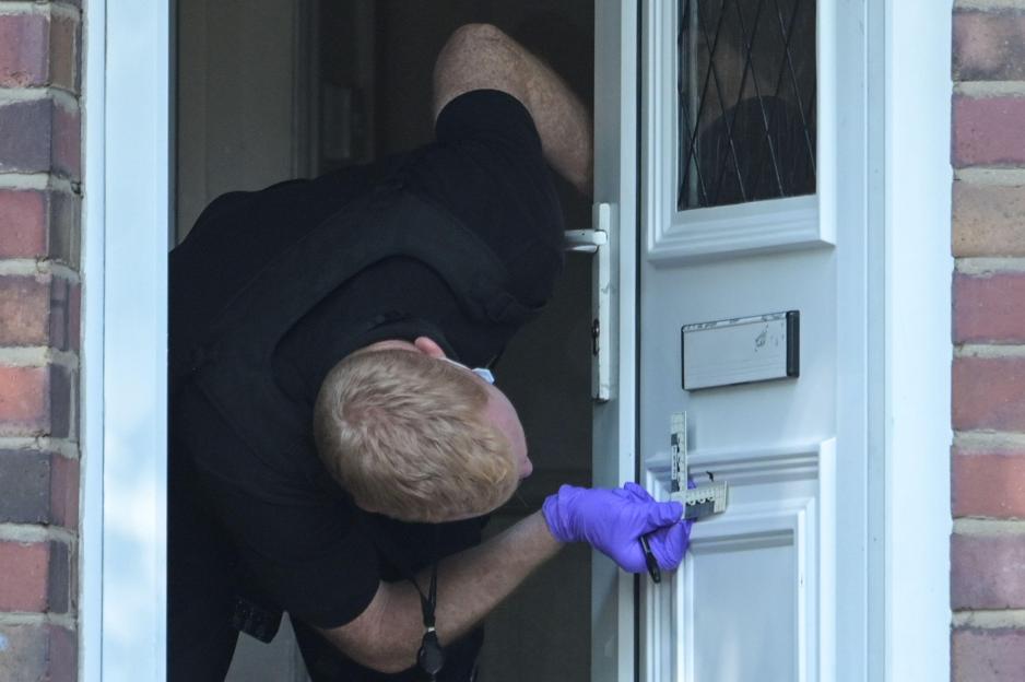 Forensic officer investigating a shooting at a home.