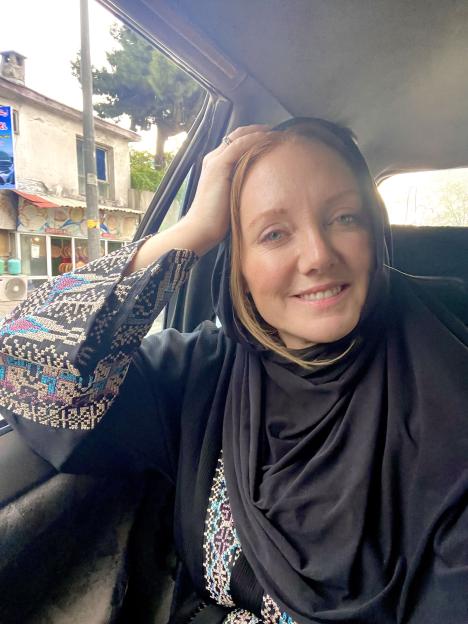 Woman wearing a headscarf in a car.
