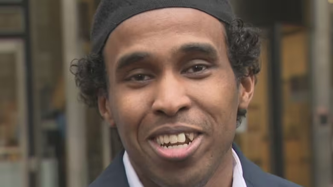 Headshot of a man smiling.